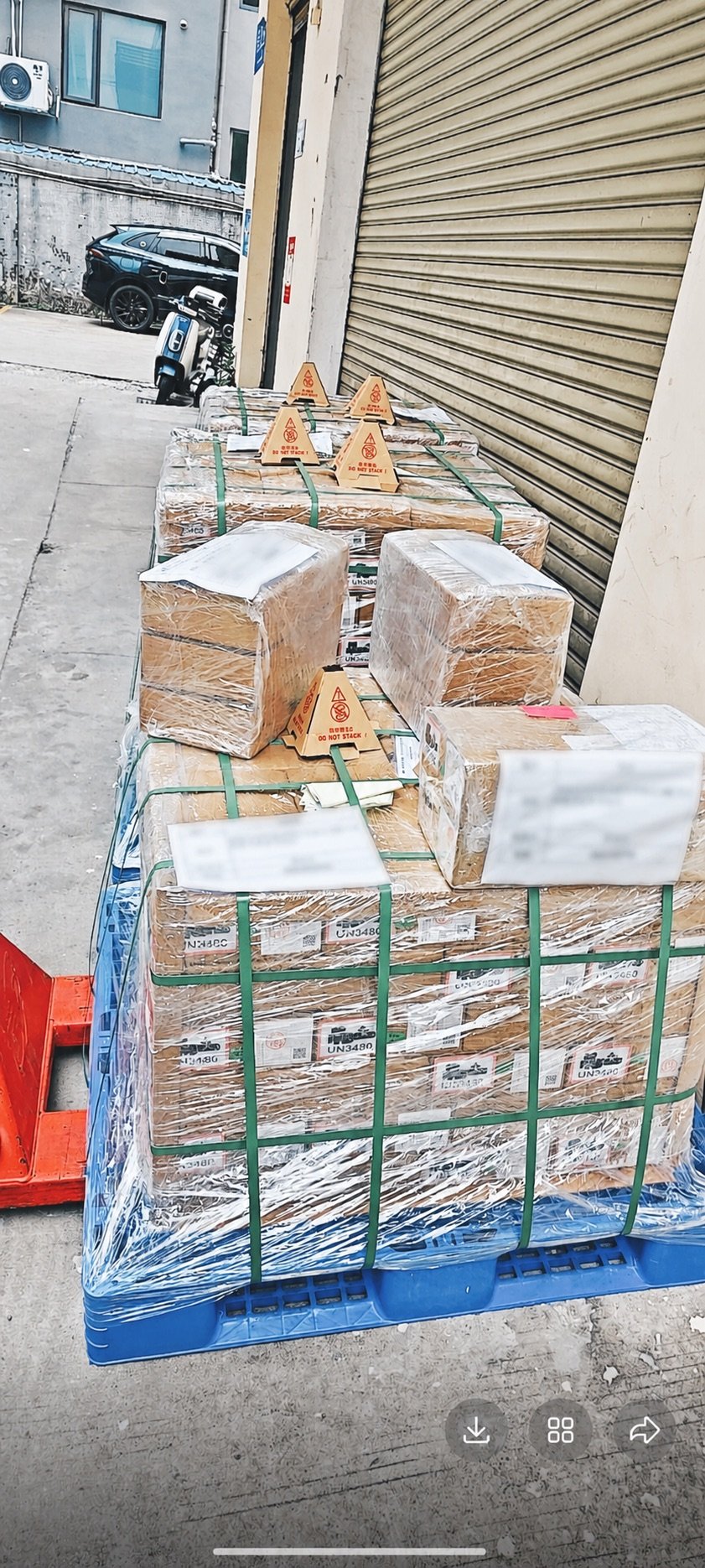 Three wrapped pallets of individually packed 21700 lithium-ion cells with UN3480 markings